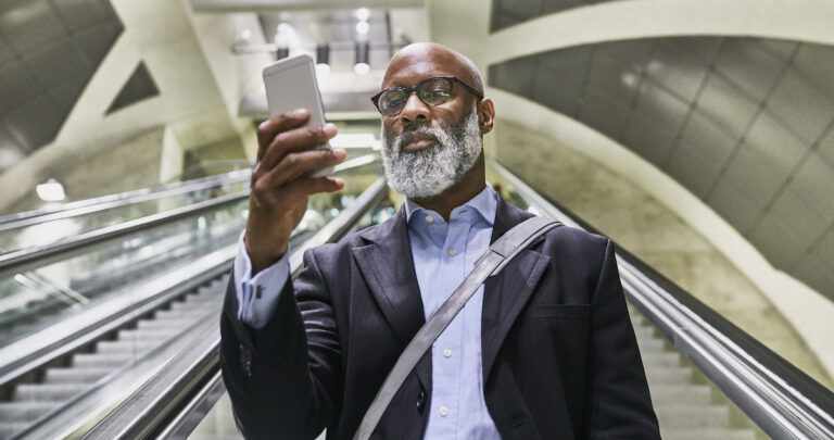 businessman-with-smartphone-reading-messages-on-es-2022-01-18-22-03-58-utc