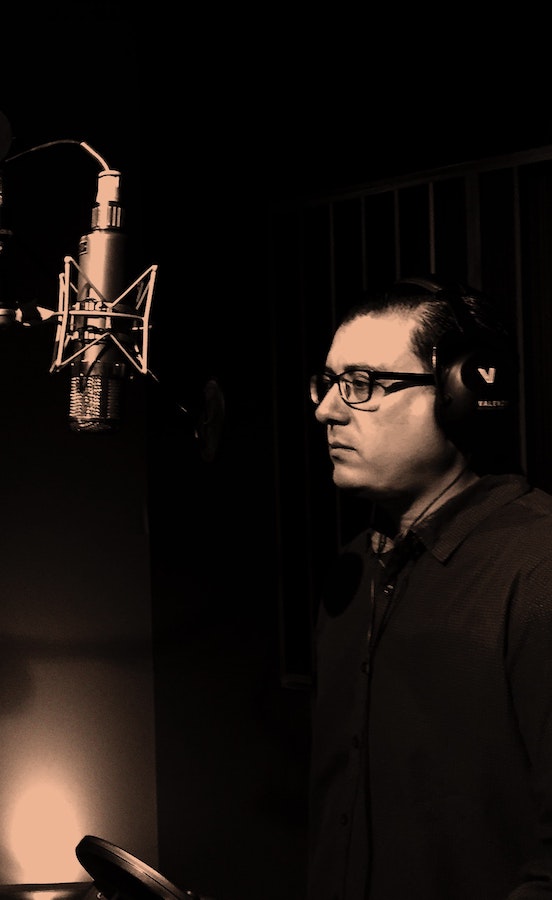 casting the right voice actor: man standing at a microphone