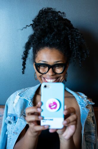 Professional voice over: image of a woman looking at a cellphone screen