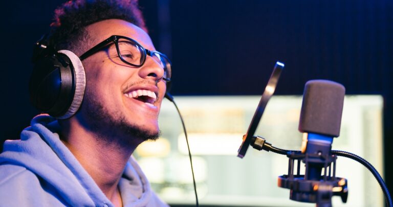 How to monetize a podcast: image of a podcaster laughing while recording