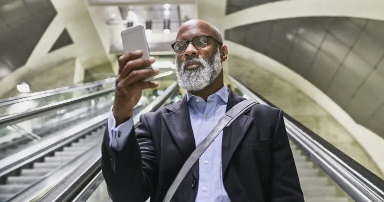 businessman-with-smartphone-reading-messages-on-es-2022-01-18-22-03-58-utc